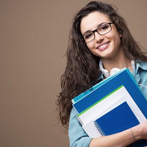 smiling-female-college-student-holding-books